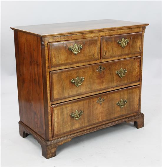 An 18th century cross banded walnut chest W. 3ft 1in. D. 1ft 7in. H. 2ft 10in.